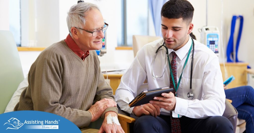 An older man talks with a doctor representing the effective communication that family caregivers should endeavor to have.