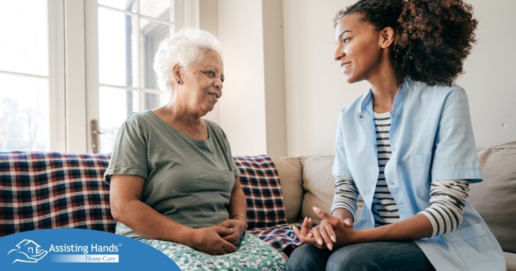 A caregiver sits and spends time with a client, representing how non-medical home care can benefit older loved ones.