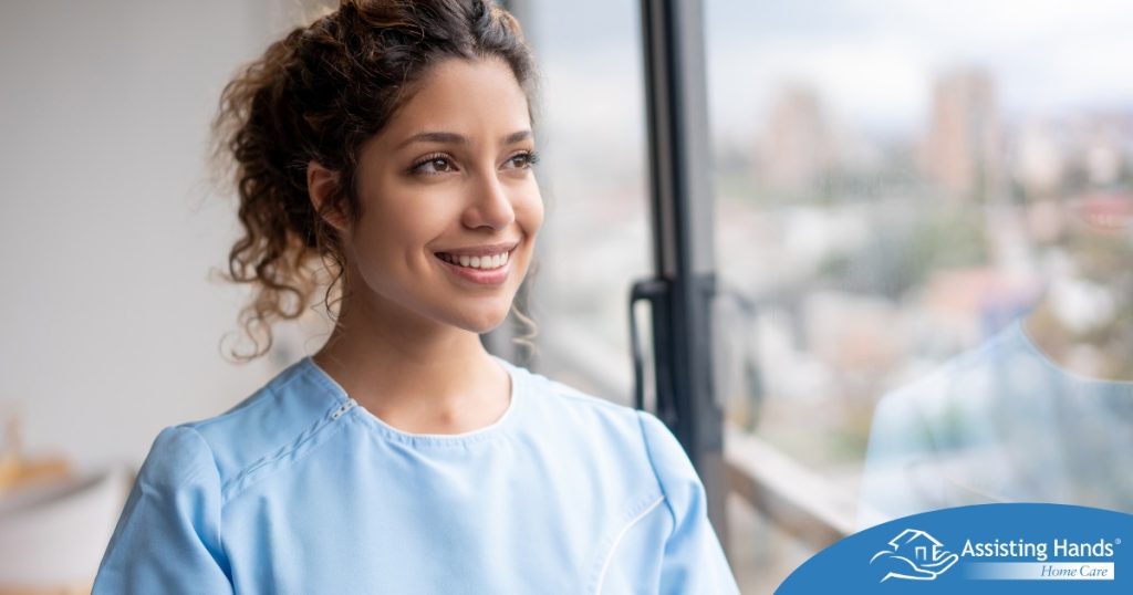 A woman smiles while looking ahead hopefully, showing the positive outlook that planning for a home care career can bring.