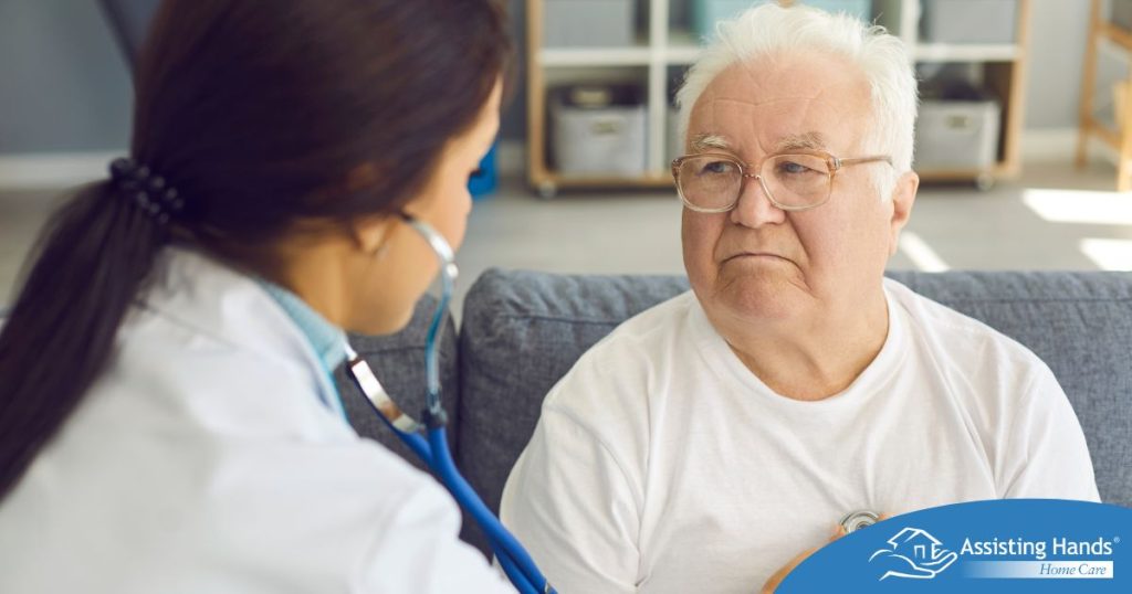 A doctor examines an older man with a stethoscope, representing pneumonia in elderly adults.