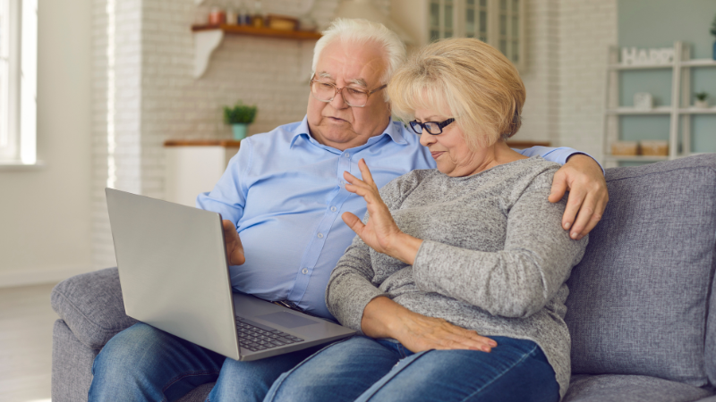 Senior couple using a computer to communicate with their loved ones out of state - Assisting Hands