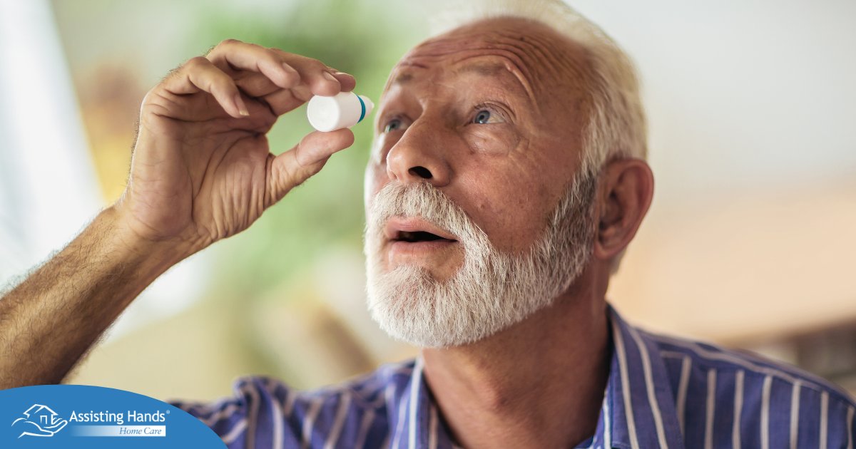 An older man uses eye drops as part of a good care routine to maintain his vision health.