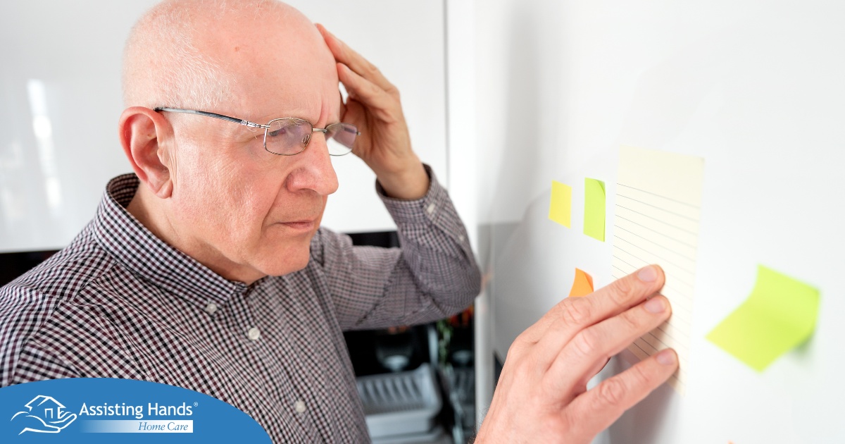 A senior looks at a board confused, representing one of the potential signs of dementia.