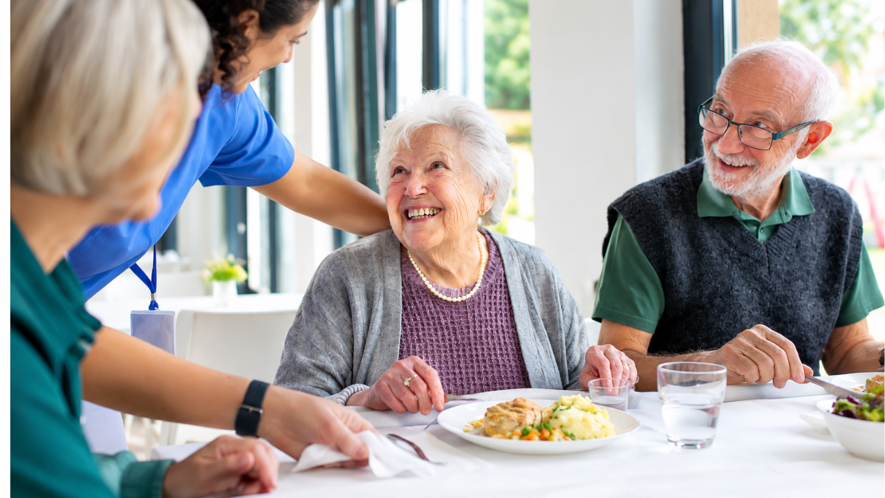 Caregiver and senior sitting together, talking and enjoying coffee at home
