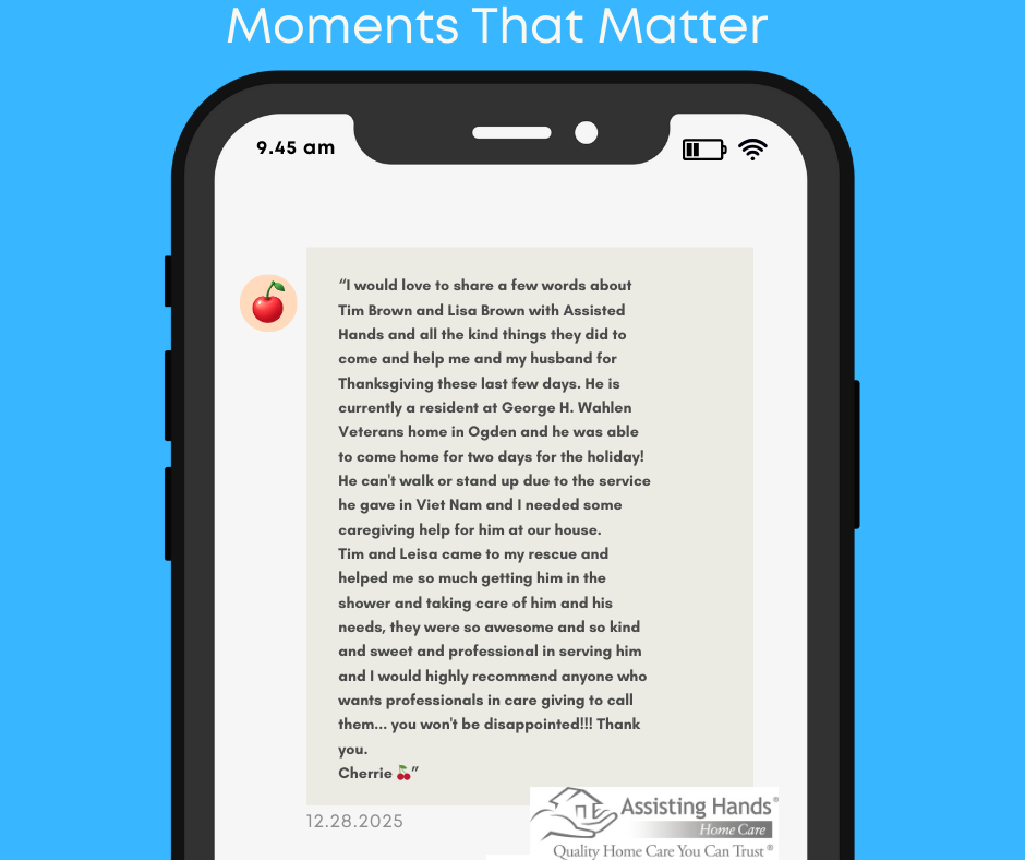 Graphic for Assisting Hands Home Care “Moments That Matter” series showing a smartphone on a blue background with a text-style testimonial from Cherrie thanking Tim and Lisa Brown for helping her Vietnam Veteran husband come home from George H. Wahlen Veterans Home for Thanksgiving and providing kind, professional caregiving support.