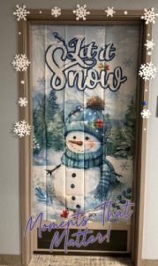 Holiday-decorated door created by a caregiver for a senior client, featuring a snowman winter scene as part of Moments That Matter at Assisting Hands Home Care.