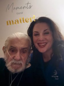 Caregiver Misty sitting closely with an elderly client receiving oxygen therapy, demonstrating compassionate in-home senior care through Assisting Hands.