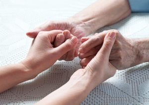 A younger hand gently holds the frail hands of an elderly person, conveying compassion, presence, and dedicated care. This image captures the heart of what long-term care in Murray, UT is truly about — ensuring that seniors are never left to navigate their needs alone. Activating your long-term care insurance in Murray, UT at the right time means your loved one can receive the senior home care in Murray, UT they deserve, with the financial support already in place. 