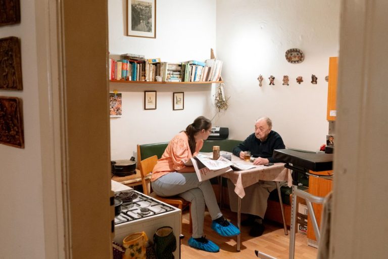 Caregiver and senior enjoying a friendly conversation at home