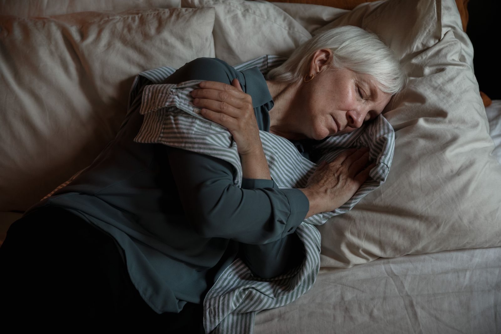 Older woman sleeping peacefully in her own bed