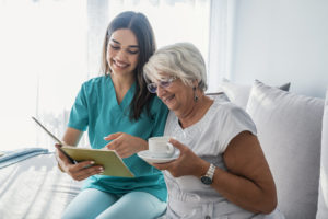 Caregiver-Senior-Reading-Drinking-Coffee