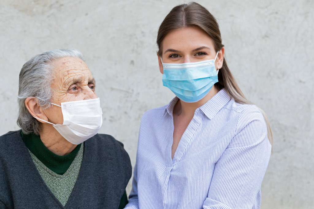 Caregiver and Senior Wearing Masks