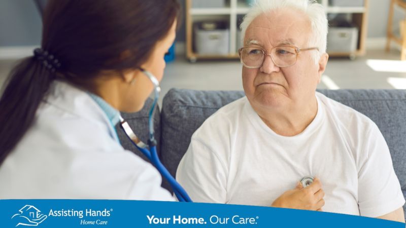 doctor using stethoscope to check senior heart