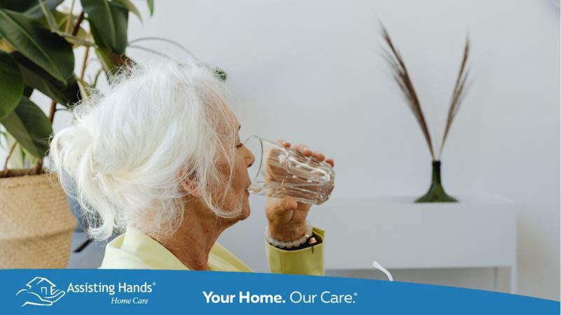 Elderly Woman Sitting on Sofa Chair While Drinking Water to Keep Up With Her Hydration