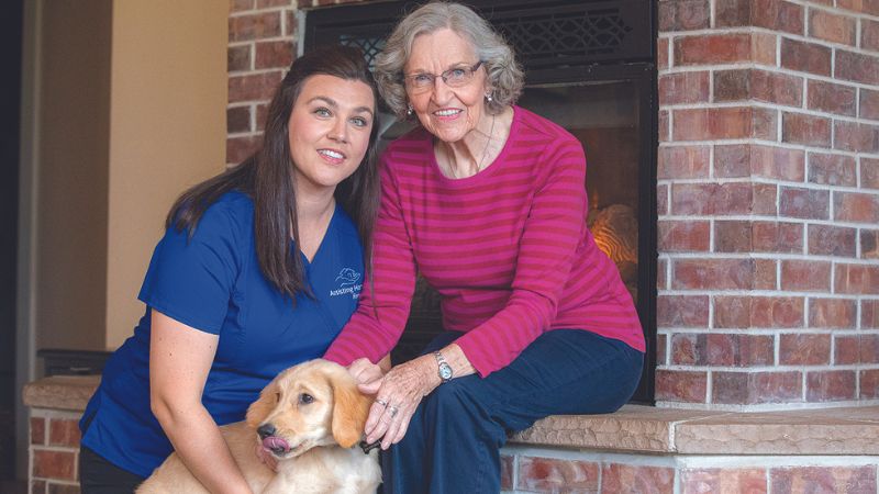 Companion Caregiver with senior woman and her dog