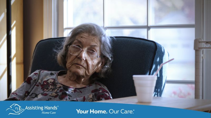 Elderly Woman With Dementia Sitting At Home and looks confused