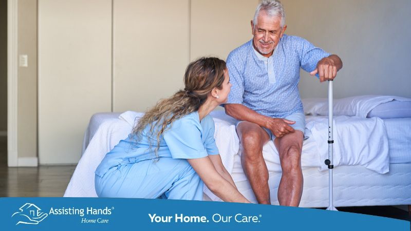caregiver adjusting the shoe lace of senior man's shoe who has parkinsons caregiver adjusting the shoe lace of senior man's shoe who has parkinsons
