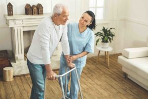 Caregiver helping patient walk