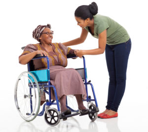 caregiver helping woman in wheelchair
