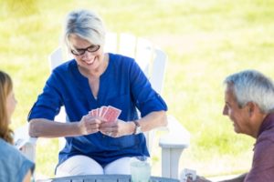 woman smiling as she plays cards