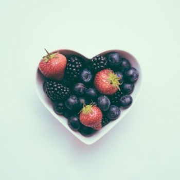 heart shaped bowl filled with fruits
