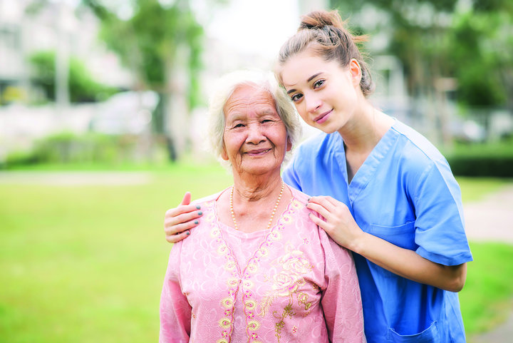 nurse caregiver with Asian elderly woman