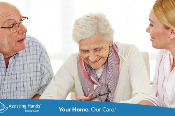 Older dementia senior man having a conversation with his wife and adult daughter