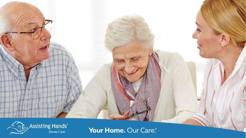 Older dementia senior man having a conversation with his wife and adult daughter
