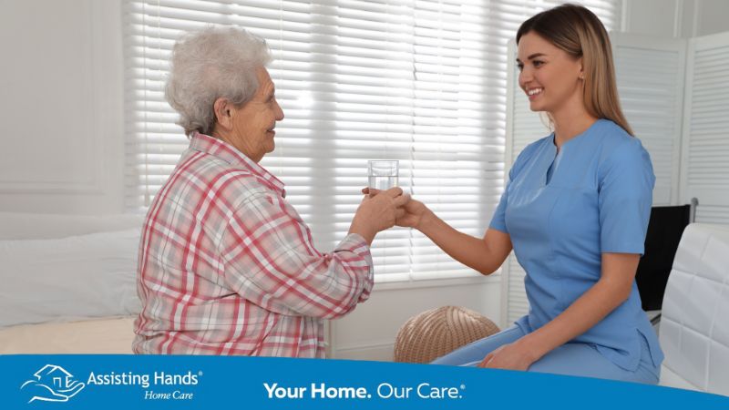 caregiver giving water to senior to prevent uti and seizure