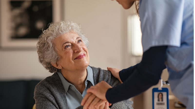 older lady smiling while social worker assists her