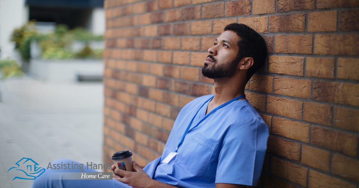An exhausted professional caregiver takes a break outside.