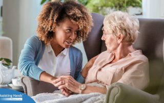 A caregiver warmly reassures an older client, showing the kind of attitude that can help clients get used to new care arrangements.
