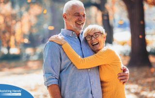 An older couple enjoys being outside in the fall, representing the idea of different fall activities for seniors.