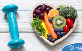 A heart with nutritious food and a dumbbell represents the healthy lifestyle that National Cholesterol Education Month promotes.
