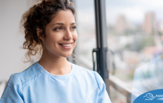 A woman in scrubs smiles, representing the satisfaction that can come with transitioning into a professional caregiving career.