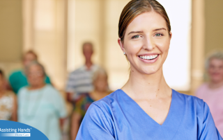 A professional caregiver smiles with seniors behind her, showing how a job with a caregiver agency can be a good choice.