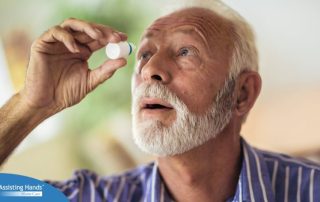 An older man uses eye drops as part of a good care routine to maintain his vision health.