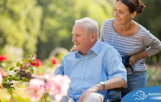 A caregiver takes a senior outside to visit a garden, highlighting one idea for senior activities.