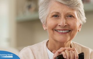 An older woman with healthy teeth smiles, representing good dental hygiene.
