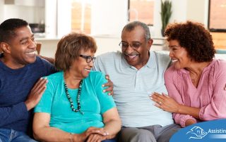 A couple sits with aging parents and enjoys their time together.