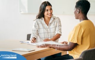A woman happily interviews another woman, representing how well caregiver interviews can go when prepared.