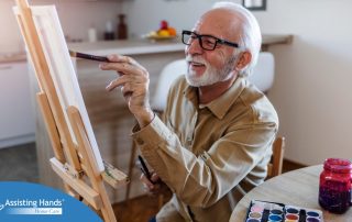 Senior man painting in his leisure time at home during the day.
