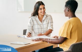 A woman smiles while being interviewed representing how well a caregiver interview can go when good questions are asked.