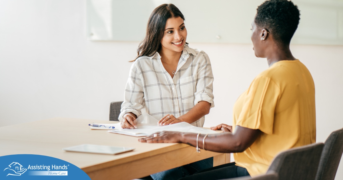 A woman smiles while being interviewed representing how well a caregiver interview can go when good questions are asked.