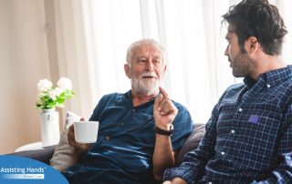 A son talks with an older parent representing the kind of communication needed to tell how aging parents are doing.