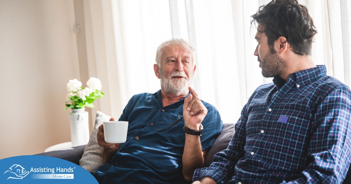 A son talks with an older parent representing the kind of communication needed to tell how aging parents are doing.