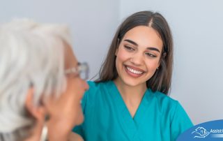 A caregiver smiles with an older client showing the results of successfully starting a new caregiving job.
