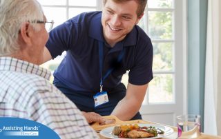 Professional caregiving involves helping clients with iADLs and ADLs as demonstrated by this caregiver helping a client by bringing a meal.