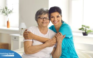 A caregiver hugs an older client, representing how a trustworthy caregiver cares for clients.