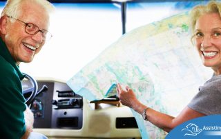 An older couple looks back smiling from the front of an RV, representing how day trips for seniors can help boost the mood of everyone.